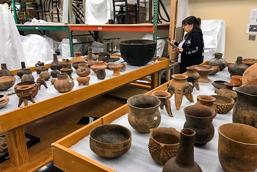 Student sitting in pottery making class